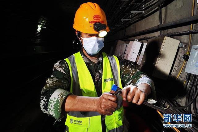 图为中国移动湖北公司工作人员在地铁隧道安装5g通信设备.